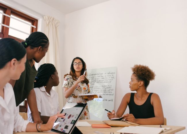 woman discussing in front of other women